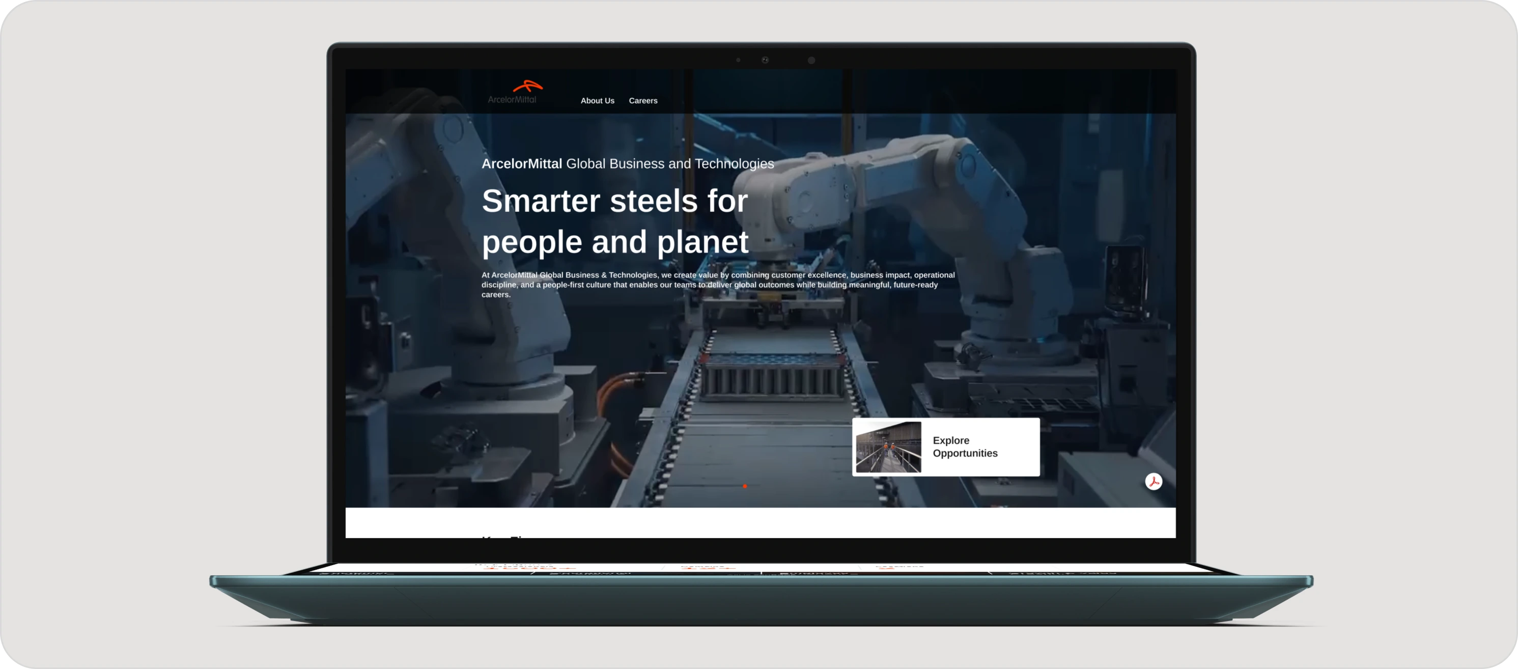 The AMGBT website shown on a laptop, headlined Smarter steels for people and planet over a robotic steel line.