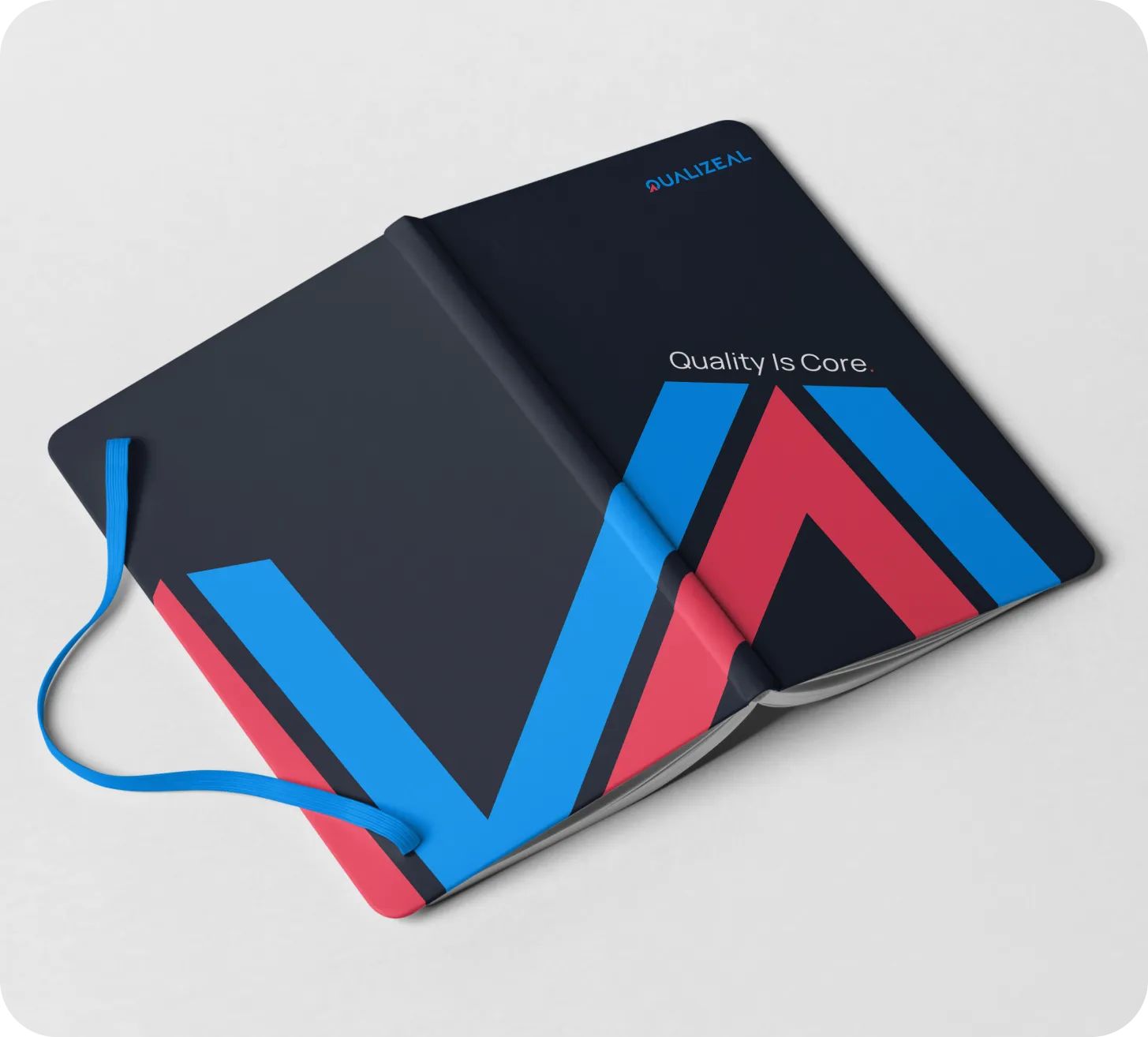 A QualiZeal notebook opened to the brand's chevron motif.