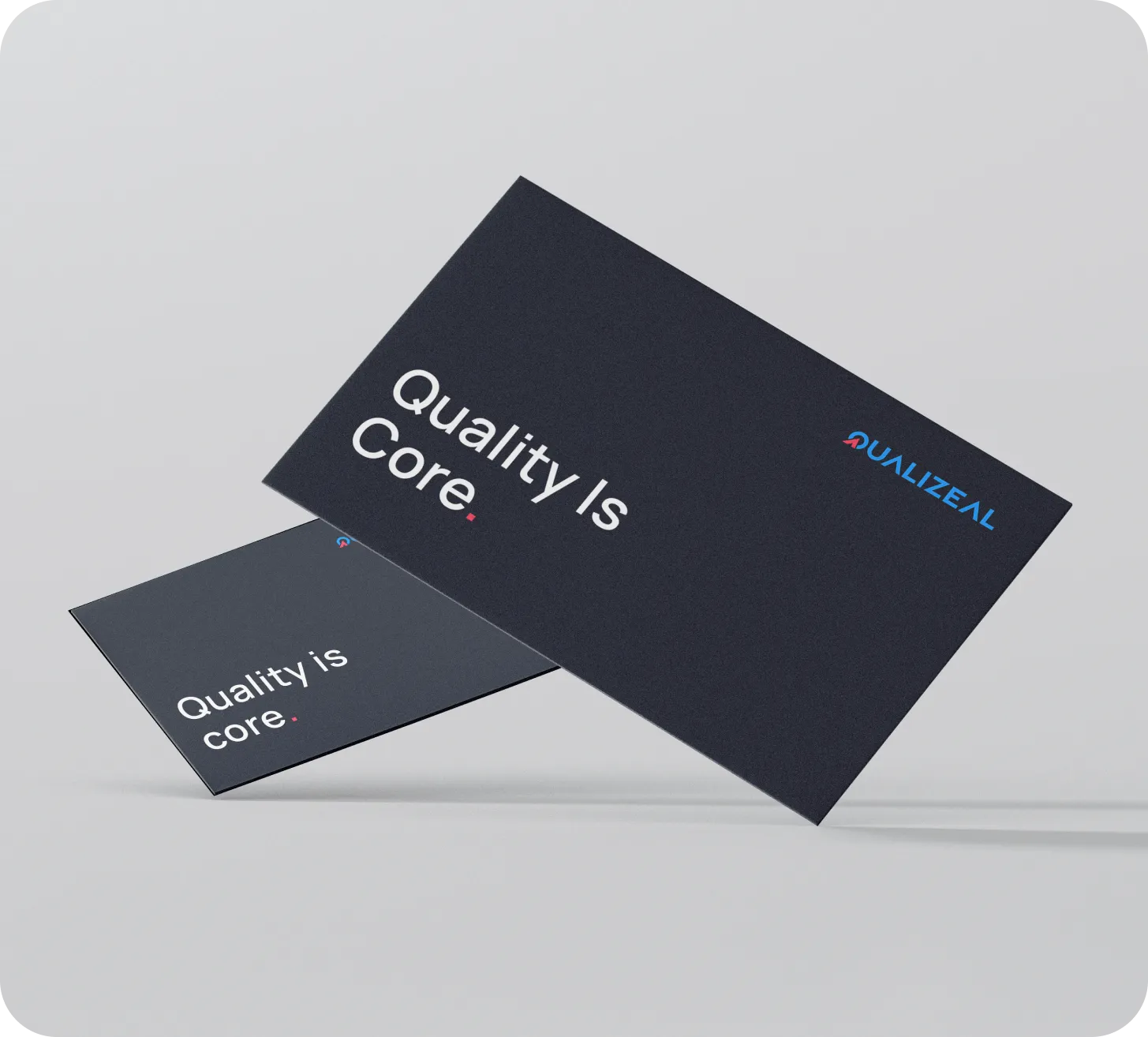 QualiZeal business cards reading Quality Is Core.
